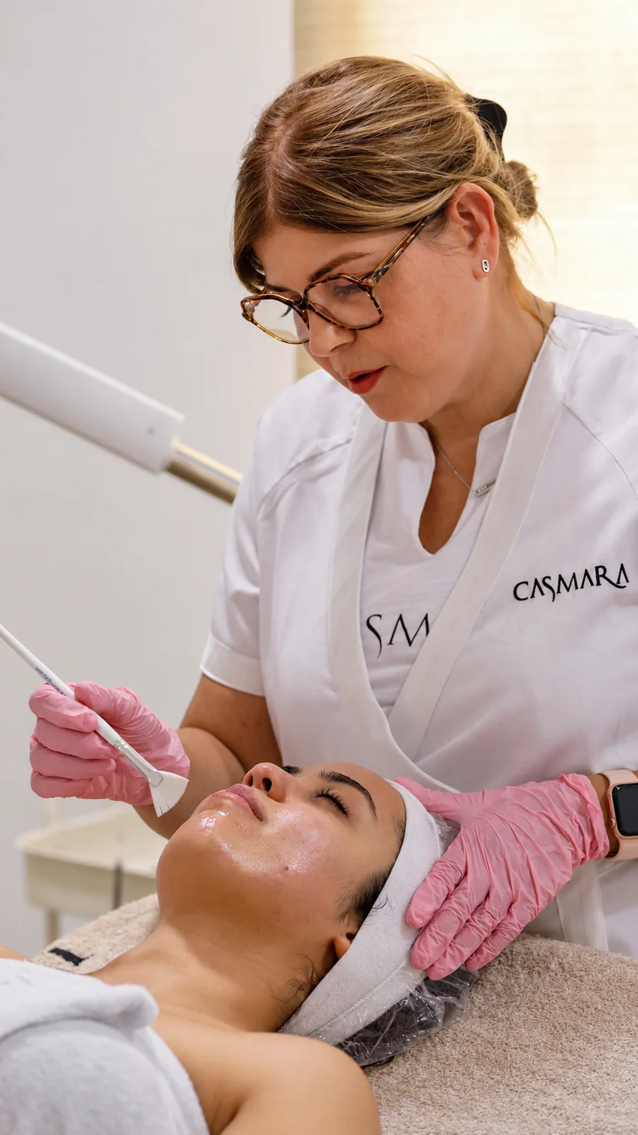 Une professionnelle du centre applique un soin du visage